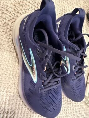 Brooks navy running shoes with light aqua accents
